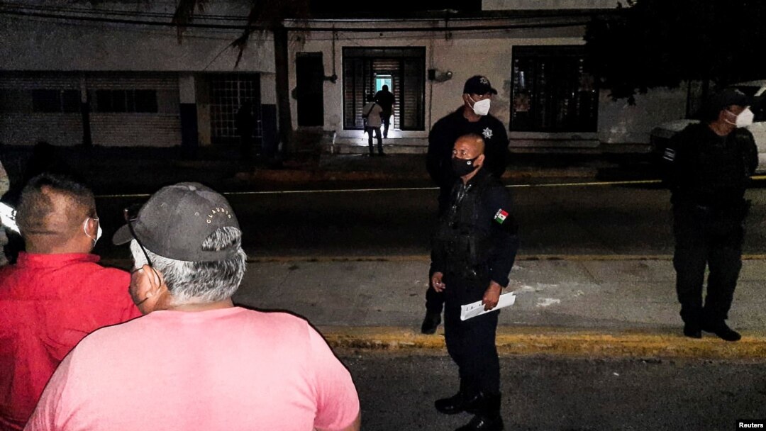 Police officers guard the perimeter of a scene where Heber Lopez, an independent journalist who ran NoticiasWeb, was shot and killed at his recording studio, in Salina Cruz, in Oaxaca state, Mexico Feb. 10, 2022. 