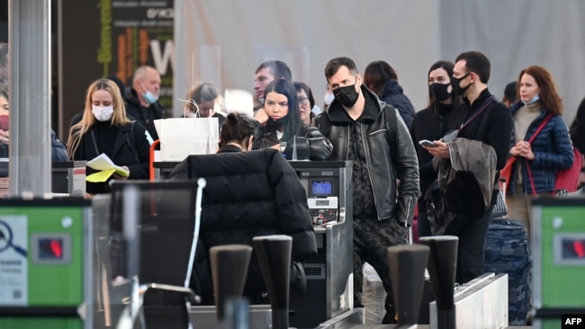 Travelers wait at the check-in counters ahead of their flights at the Boryspil airport some 30 kilometers outside Kyiv on Feb. 13, 2022.