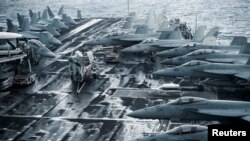 F/A-18E and 18F Super Hornets are seen on the flight deck of the Nimitz-class aircraft carrier <em>USS Harry S. Truman</em> (CVN 75) in the Adriatic Sea, off Split, Croatia.