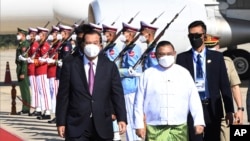 FILE. - Cambodian Prime Minister Hun Sen, left, reviews an honor guard with Myanmar Foreign Minister Wunna Maung Lwin, front right, on his arrival at Naypyitaw International Airport in Naypyitaw, Myanmar, on Jan 7, 2022. (An Khoun Sam Aun/National Television of Cambodia via AP)