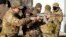 An instructor shows a woman how to use a Kalashnikov assault rifle, as members of a Ukrainian far-right group train, in Kyiv, Feb. 13, 2022.