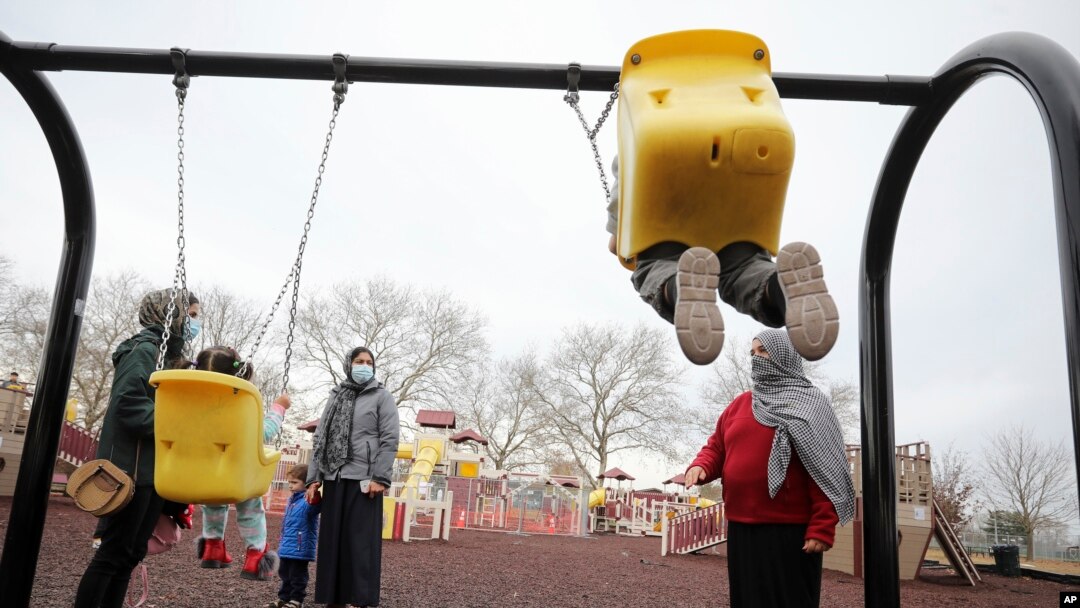 FILE - Afghan refugee mothers and children play in a park on Joint Base McGuire-Dix- Lakehurst in Trenton, N.J., Dec. 2, 2021.