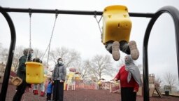 FILE - Afghan refugee mothers and children play in a park on Joint Base McGuire-Dix- Lakehurst in Trenton, N.J., Dec. 2, 2021.