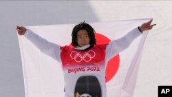 Japan's Ayumu Hirano celebrates winning the men's halfpipe gold medal during the at the 2022 Winter Olympics, Feb. 11, 2022.