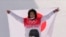 Japan's Ayumu Hirano celebrates winning the men's halfpipe gold medal during the at the 2022 Winter Olympics, Feb. 11, 2022.