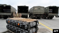 Ukrainian servicemen receive the delivery of FGM-148 Javelins, American man-portable anti-tank missile provided by the U.S. to Ukraine, at Kyiv's airport Boryspil, Feb. 11, 2022.