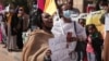 Women chant slogans protesting violence against women and demanding the release of all detainees before the UN rights office in Khartoum, Sudan, Feb. 2, 2022. 