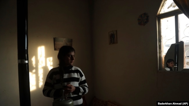 Roza Barakat poses for a portrait in a safe house in Hassakeh, Syria, Sunday, Feb. 6, 2022.