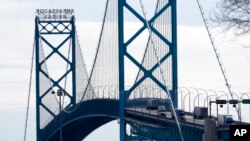 Traffic flows over the Ambassador Bridge in Detroit, Feb. 14, 2022, after protesters blocked the major border crossing for nearly a week in Windsor, Ontario.