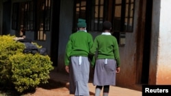 Sitienei walks with her classmate. Picture taken January 25, 2022. REUTERS/Monicah Mwangi