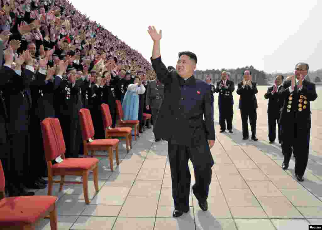 Cadet from the Korea Naval Academy reacts after receiving a garland from the winner of the 2013 Miss Korea Pageant during a parade to mark the 65th anniversary of Korea Armed Forces Day in central Seoul, South Korea. 