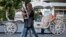 Girls walk past a carriage in Odessa, Ukraine, May 7, 2014. 