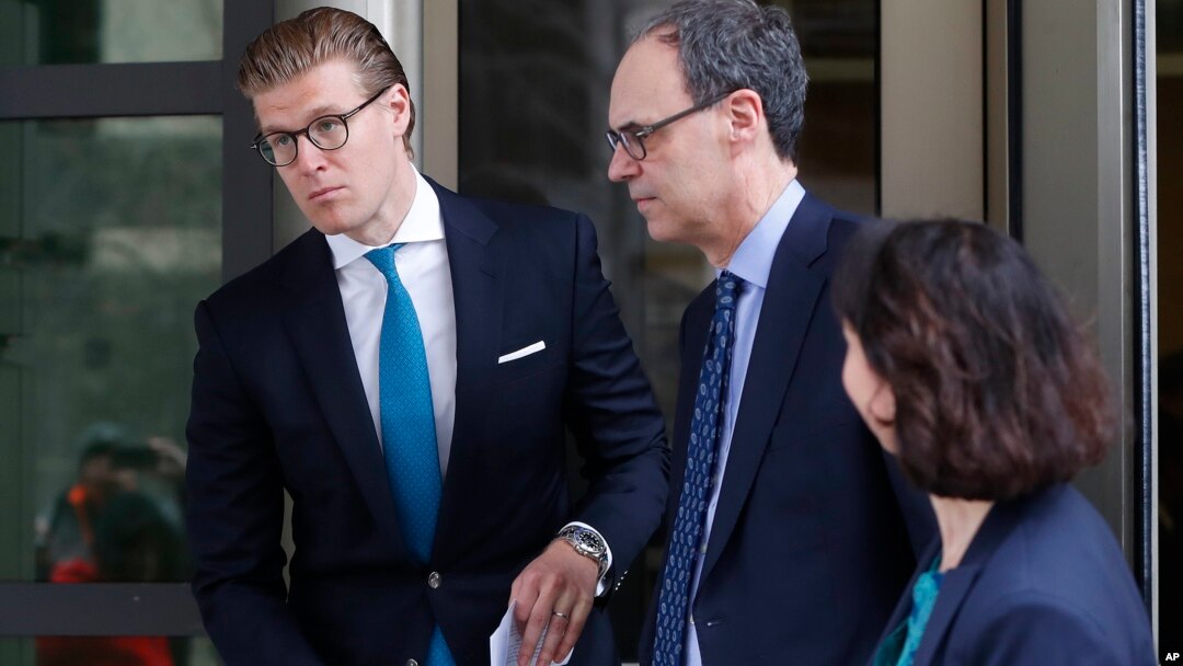 Alex van der Zwaan, left, leaves Federal District Court in Washington, April 3, 2018. A federal judge sentenced Alex van der Zwaan to 30 days in prison.