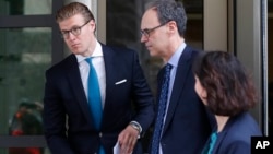 Alex van der Zwaan, left, leaves Federal District Court in Washington, April 3, 2018. A federal judge sentenced Alex van der Zwaan to 30 days in prison.