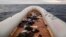 FILE - Migrants' personal belongings lie in a rubber boat after the people were rescued by aid workers of the Spanish NGO Proactiva Open Arms, 60 miles north of Al-Khums, Libya, Feb. 18, 2018. The migrants had left Libya in an effort to reach European soil.