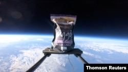 The first pack of haggis to ever be launched into space floats in atmosphere attached to a contraption device from the company’s headquarters in Dunning, southwest of Perth, Scotland, into a clear sky, Jan 22, 2021.