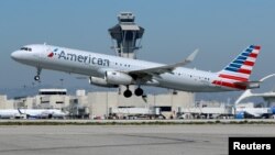 FILE - An American Airlines plane takes off from Los Angeles International Airport in Los Angeles, California, March 28, 2018. 