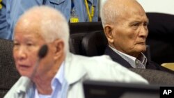 In this photo released by the Extraordinary Chambers in the Courts of Cambodia, Khieu Samphan, left, former Khmer Rouge head of state, and Nuon Chea, right, who was the Khmer Rouge's chief ideologist and No. 2 leader, sit in the court hall before they made closing statements at the U.N.-backed war crimes tribunal in Phnom Penh, file photo. 