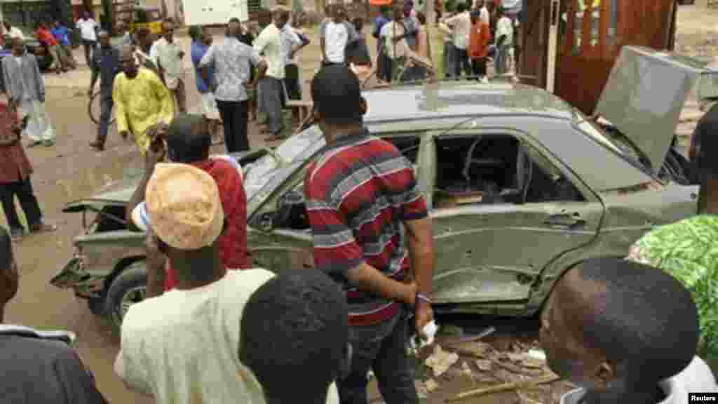 People gather at the site of an explosion at Sabon gari in Kano, Nigeria. Tuesday, July. 30, 2013.