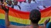 FILE - People protest against the sentencing of two men in Malawi under Malawi's anti-gay legislation in Cape Town, South Africa, May 20, 2010. Two Kenyan men have filed a constitutional petition against forced anal examinations to "prove homosexuality."