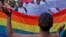 FILE - People protest against the sentencing of two men in Malawi under Malawi's anti-gay legislation in Cape Town, South Africa, May 20, 2010. Two Kenyan men have filed a constitutional petition against forced anal examinations to "prove homosexuality."