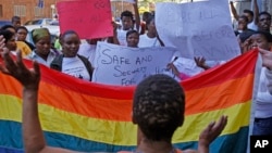 FILE - Women protest against a sentence of 14 years in prison, with hard labor, given to two men in Malawi under anti-gay legislation, in the city of Cape Town, South Africa, May 20, 2010. A high court in Malawi has ordered the annulment of a government moratorium issued in 2012 that suspended a law criminalizing homosexual acts.
