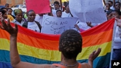 FILE - Women protest against a sentence of 14 years in prison, with hard labor, given to two men in Malawi under Malawi's anti-gay legislation, in the city of Cape Town, South Africa, May 20, 2010. The Malawian government has reaffirmed its decision to halt the arrest and while lawmakers review existing anti-gay laws.