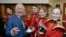 Prince Charles shares a light moment with members of the Welsh Guards band at a remembrance service at the Guards' Chapel, Wellington Barracks in London, Nov. 11, 2018.