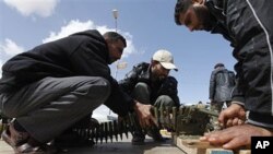 Anti-Gadhafi rebels prepare anti-aircraft ammunition in Ras Lanouf, eastern Libya, March 8, 2011