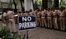 A police officer gives instructions in Mumbai, Nov. 9, 2019. India's security forces were on high alert ahead of the Supreme Court's verdict Saturday in a decades-old dispute between Muslims and Hindus over plans to build a Hindu temple.