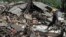 A rescuer walks on the rubble of houses in an area affected by an earthquake in Kalibening, Central Java, Indonesia, April 19, 2018. 