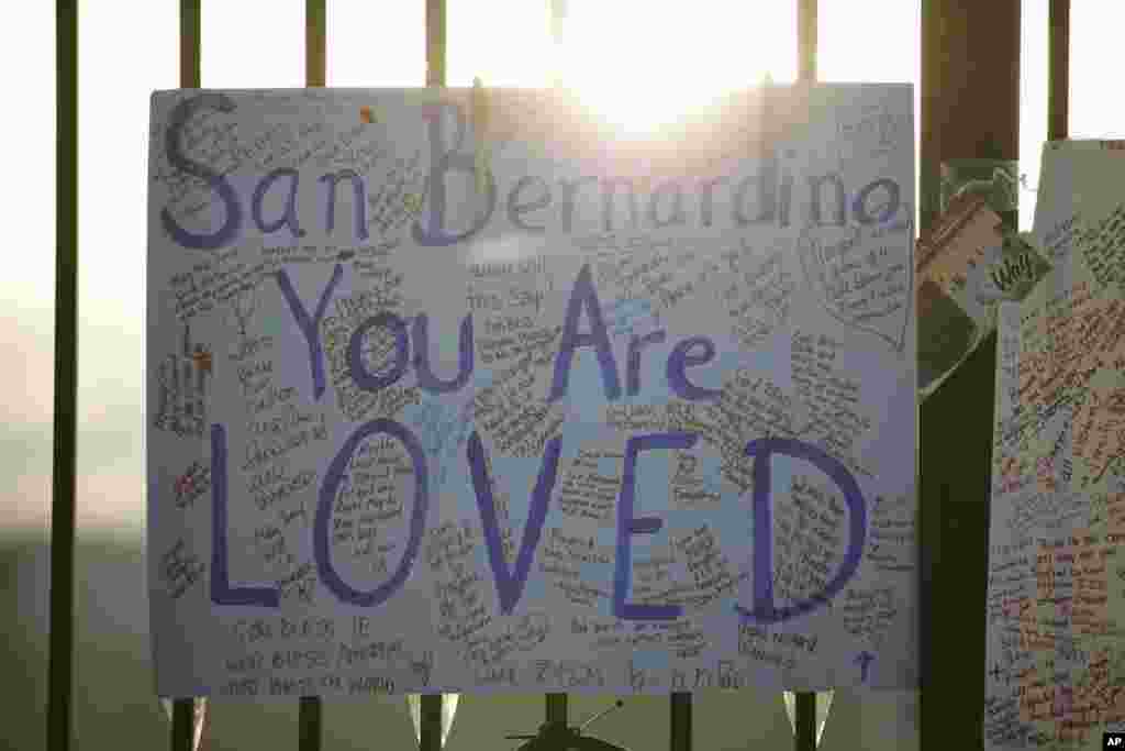 A sign honoring the victims of Wednesday's shooting rampage is seen at makeshift memorial, Dec. 6, 2015, in San Bernardino, Calif. 