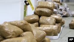 FILE - In this undated photo provided by the Australian Federal Police, packages containing methamphetamine seized in a shipment coming from China are stacked in a warehouse in Melbourne, Australia.