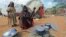 Kadija Mohamed cooks food for her children in a camp set up for internally displaced people in Dinsoor, in southern Somalia, January 5, 2012.