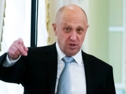 FILE - Kremlin-linked businessman Yevgeny Prigozhin gestures on the sidelines of a meeting at the Konstantin palace outside St. Petersburg, Russia, Aug. 9, 2016.