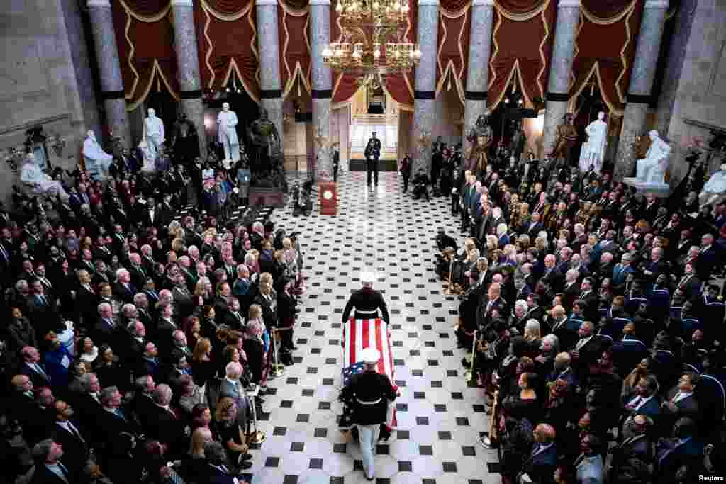 The flag-draped casket of the late U.S. Representative Elijah Cummings (D-MD) is carried through National Statuary Hall during a memorial service at the U.S. Capitol in Washington.