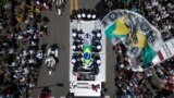 Le cercueil de Pelé, drapé du drapeau brésilien, est transporté dans les rues de Santos, au Brésil, le mardi 3 janvier 2023. (AP Photo/Matias Delacroix)
