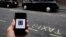 FILE - A photo illustration shows the Uber app logo displayed on a mobile telephone, as it is held up for a posed photograph in central London, Britain October 28, 2016. 
