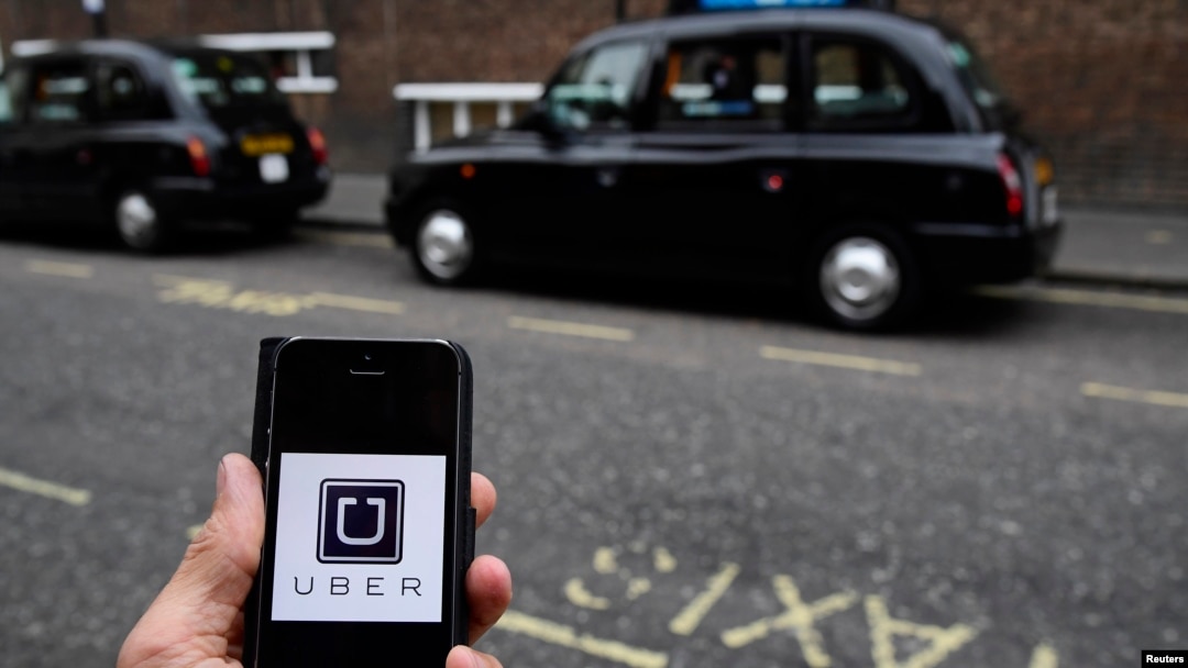 FILE - A photo illustration shows the Uber app logo displayed on a mobile telephone, as it is held up for a posed photograph in central London, Britain October 28, 2016. 