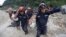 Rescue workers carry a body away from the site of a landslide in Santa Catarina Pinula, on the outskirts of Guatemala City, Oct. 2, 2015.