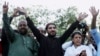 FILE - Manzoor Pashteen, center, leader of Pakistan’s Pashtun Tahafuz Movement (PTM), waves to his supporters during a rally in Lahore, Pakistan, April 22, 2018. 