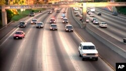 FILE - In this June 17, 1994, file photo, a white Ford Bronco, driven by Al Cowlings carrying O.J. Simpson, is trailed by Los Angeles police cars as it travels on a freeway in Los Angeles.