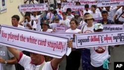 FILE - Activists hold placards as they march for a protest a government decision to allow people without full citizenship, including members of the Rohingya ethnic minority, to vote in an upcoming constitutional referendum, Feb. 11, 2015 in Yangon, Myanma