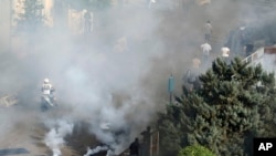 Lebanese riot police fire tear gas during clashes between Hezbollah supporters and anti-government protesters, in Beirut, Lebanon, Oct. 29, 2019.