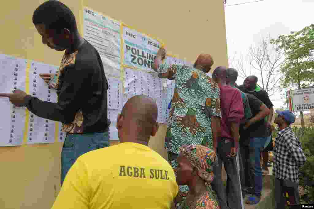 People looks for their names on voters&#39; list put up on a wall, at a polling unit, during Nigeria&#39;s Presidential election, in Lagos, Nigeria February 25, 2023.&nbsp;