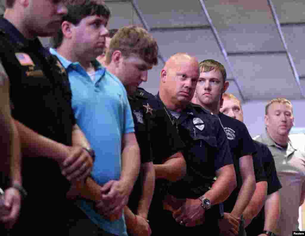 Police officers attend a vigil after a fatal shooting of Baton Rouge policemen, at Saint John the Baptist Church in Zachary, Louisiana, July 17, 2016. 