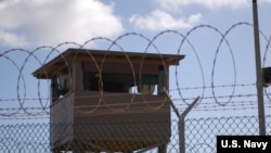 FILE - A soldier stands guard in a tower at Camp Delta at Joint Task Force Guantanamo Bay. (US Army photo)