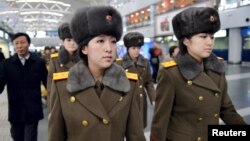 Members of the Moranbong Band of North Korea arrive at Beijing International Airport before departing from Beijing, China, on Dec. 12, 2015.