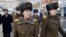 Members of the Moranbong Band of North Korea arrive at Beijing International Airport before departing from Beijing, China, on Dec. 12, 2015.