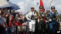 Chinese People's Liberation Army (PLA) soldiers take part in a flag-raising ceremony during the opening day of Stonecutter Island Navy Base in Hong Kong to mark the 19th anniversary of the Hong Kong handover to China, July 1, 2016.